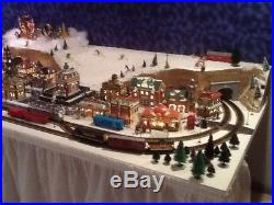 Christmas Village and HO train set. 16 buildings and over 35 ft of track