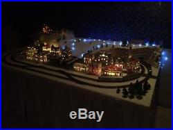 Christmas Village and HO train set. 16 buildings and over 35 ft of track